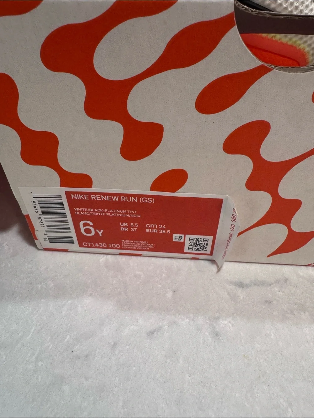 Nike White Running Shoe with Pink and Orange Accents